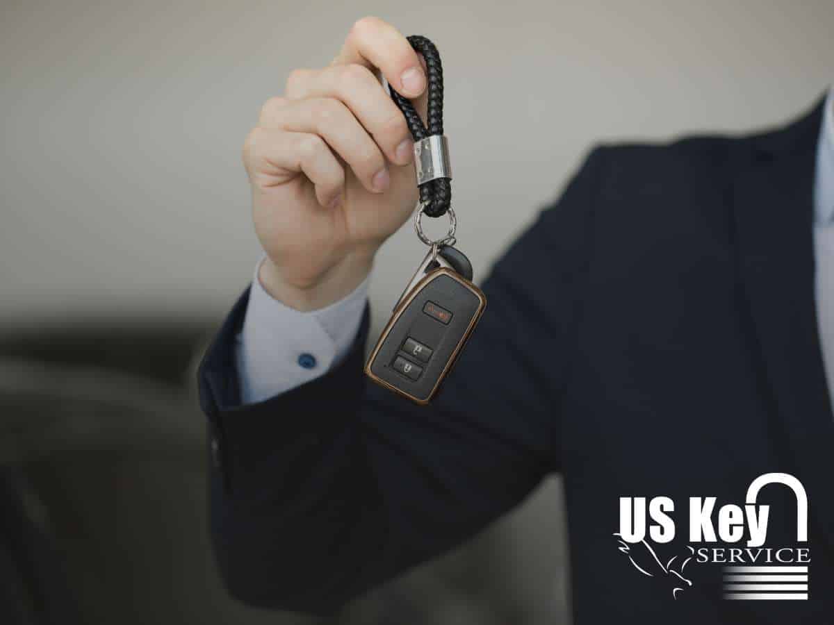 Man in a suit holding a spare car key, emphasizing the importance of having a backup to avoid lockouts and costly replacements